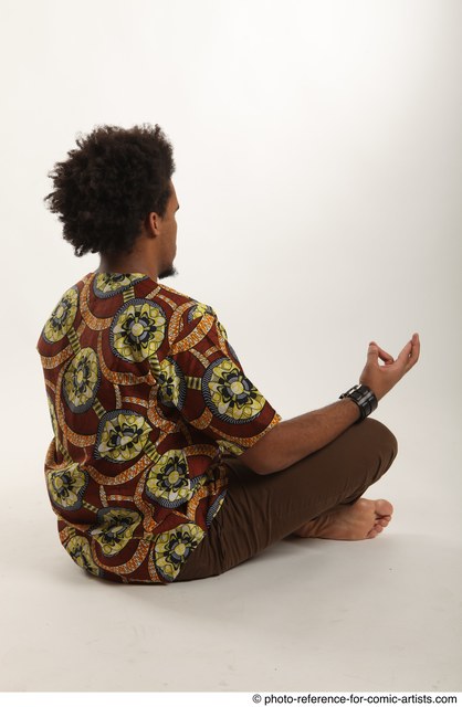 Man Adult Average Black Neutral Sitting poses Casual