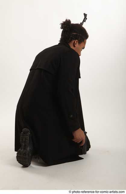 Man Adult Average Black Fighting with gun Sitting poses Coat
