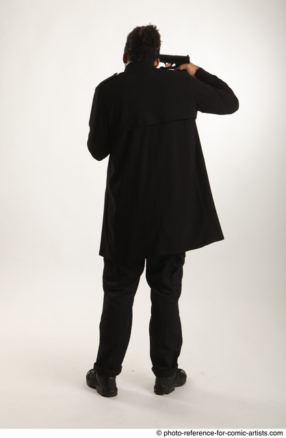 Man Adult Average Black Fighting with gun Standing poses Coat
