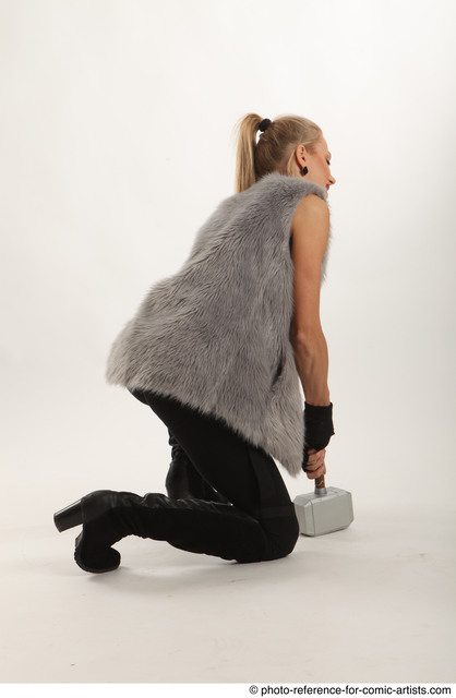 Woman Adult Average White Fighting with hammer Kneeling poses Coat