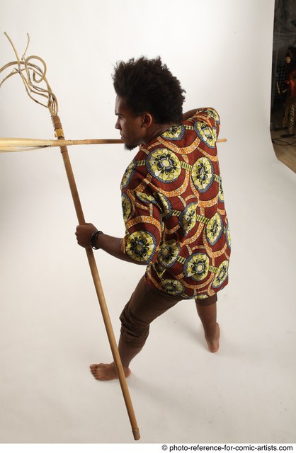 Man Adult Average Black Fighting with spear Standing poses Coat