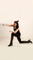 claudia-kneeling-aiming-pistol