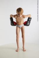 STANDING YOUNG BOY WITH BOX GLOVES NOVEL 01