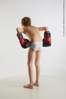 STANDING YOUNG BOY WITH BOX GLOVES NOVEL 04