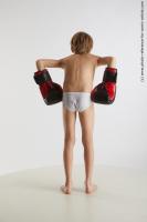 STANDING YOUNG BOY WITH BOX GLOVES NOVEL 05