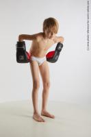 STANDING YOUNG BOY WITH BOX GLOVES NOVEL 08